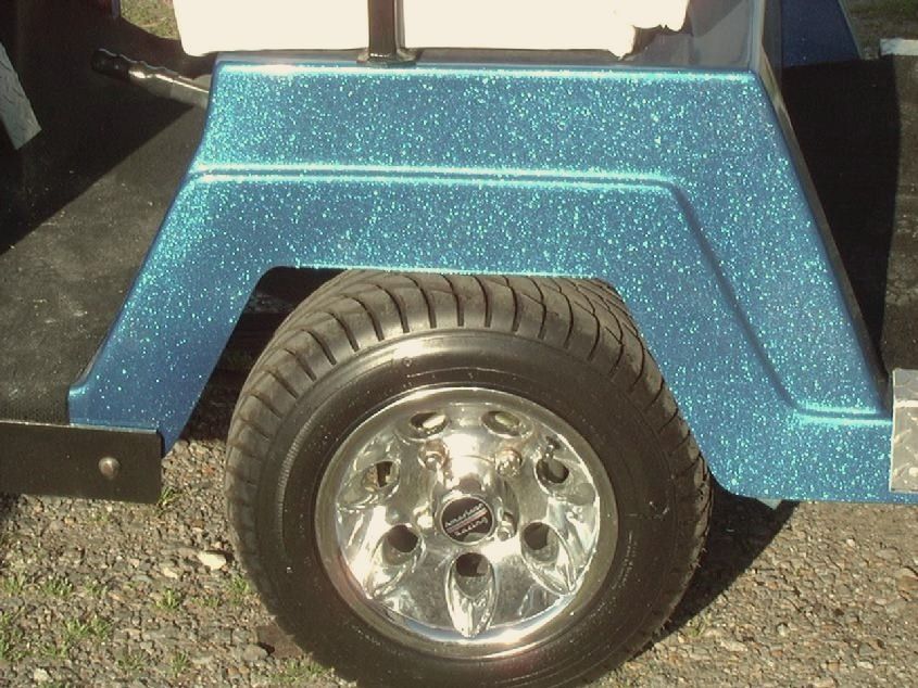 A close-up of sparkling metal-flake blue custom paint