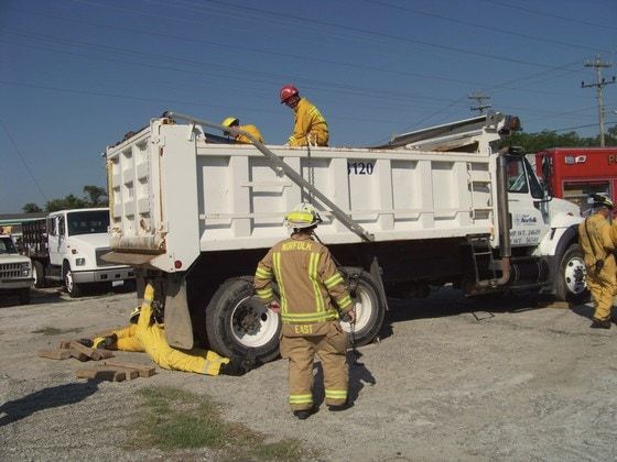 Firefighters practicing a rescue on a dump truck in the GAC yard