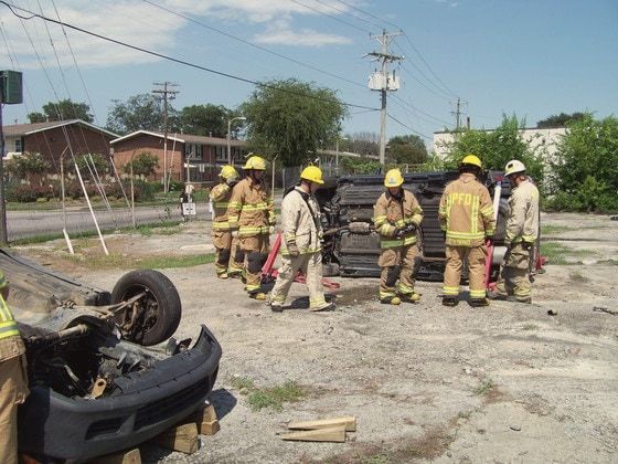 Firefighters practicing a rescue from an overturned car in the GAC yard