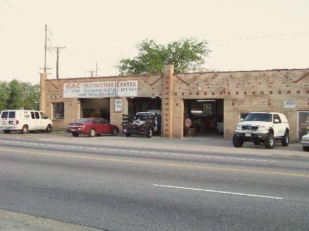The tan brick GAC Automotive Center building on Portsmouth Blvd, with its service bays open
