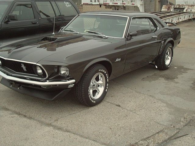 A restored 1969 Ford Mustang finished in near-black paint