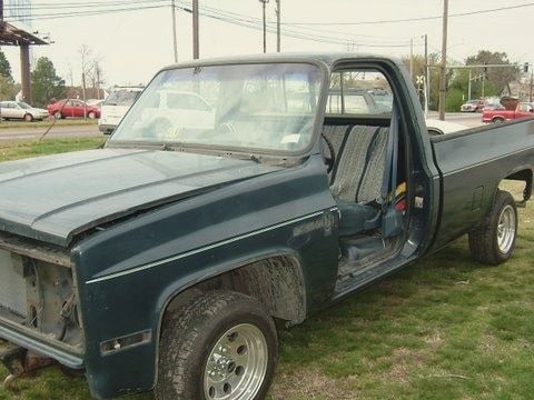 A worn square-body Chevy pickup before bodywork