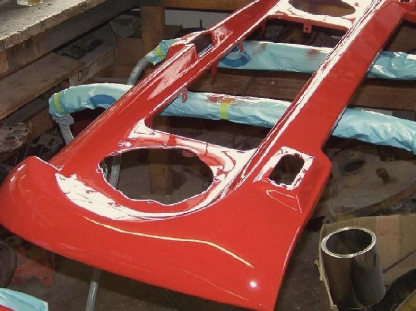 A freshly painted red Scout body panel