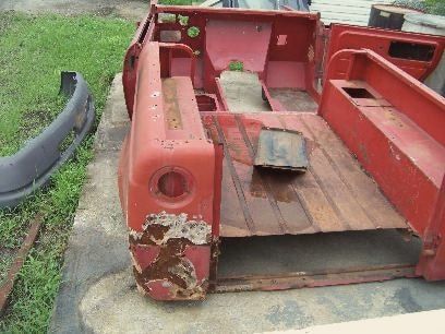 The rusty red tub of a 1969 International Scout before restoration