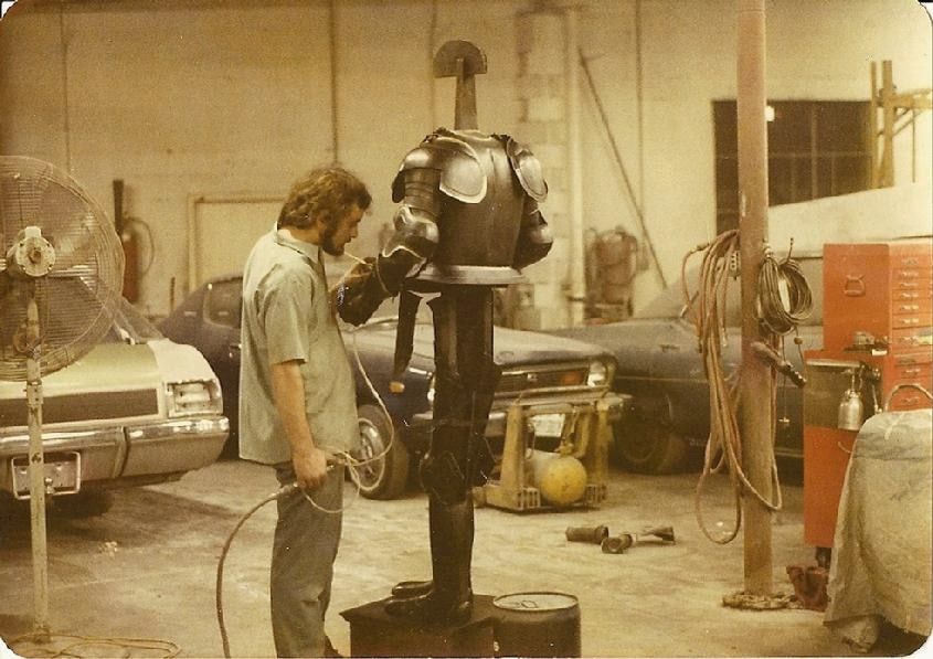 An old print of a painter at work on the shop floor