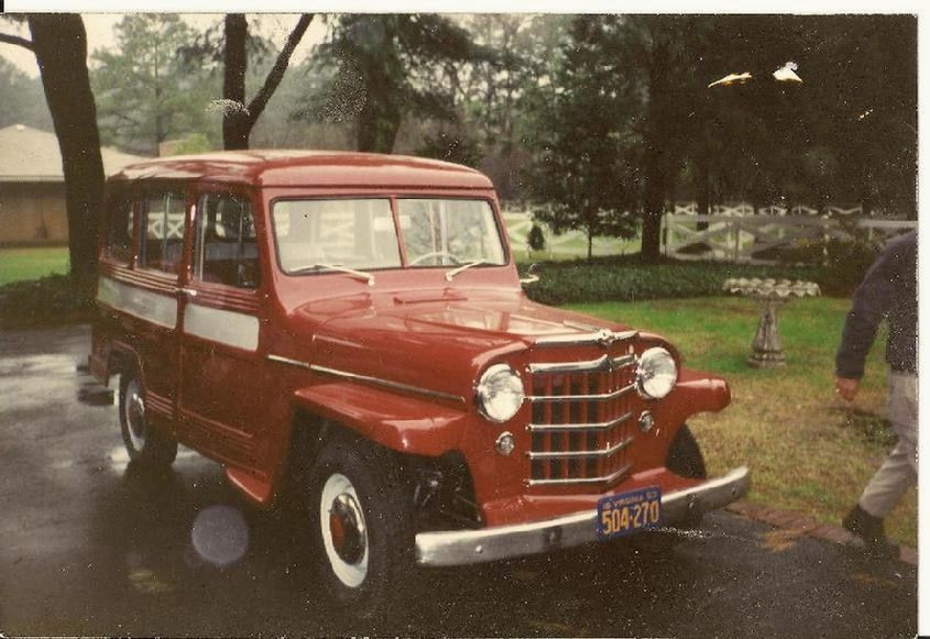 An old photo of the same Willys station wagon restored in red