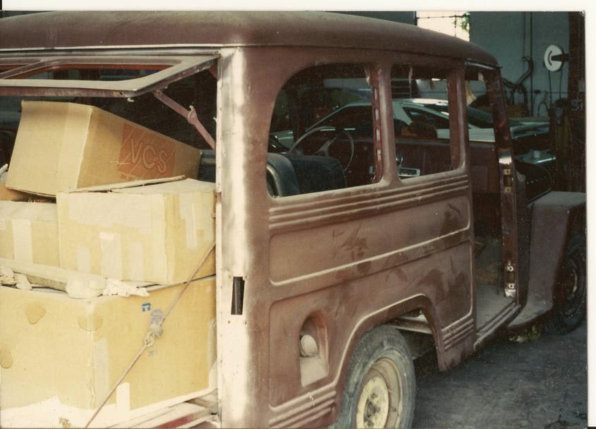An old photo of a worn Willys station wagon before restoration